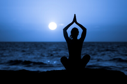 Silhouette of Young Woman Doing Yoga